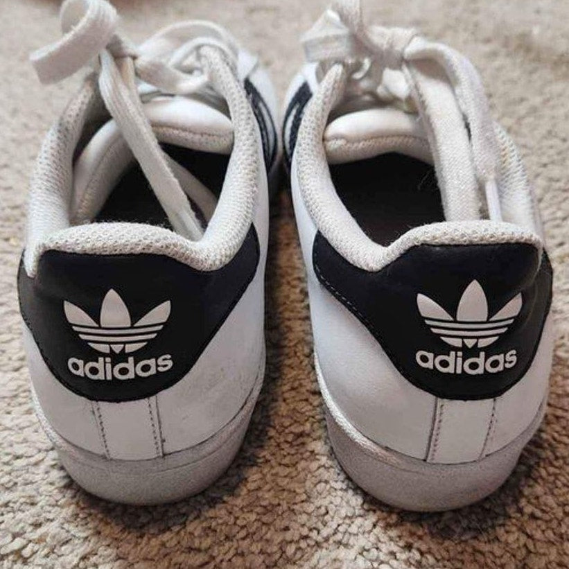 Adidas white low top superstars with black Adidas three stripes 5.5 men 7.5 women