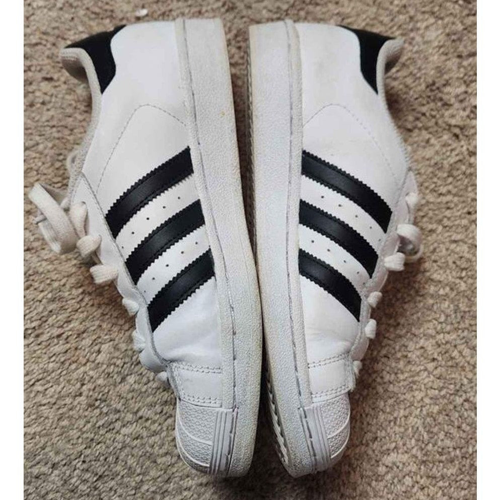 Adidas white low top superstars with black Adidas three stripes 5.5 men 7.5 women