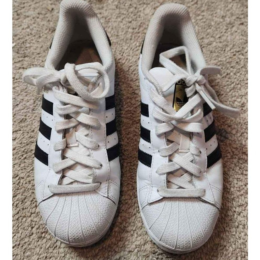 Adidas white low top superstars with black Adidas three stripes 5.5 men 7.5 women