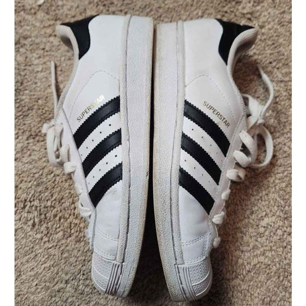 Adidas white low top superstars with black Adidas three stripes 5.5 men 7.5 women